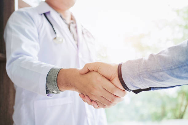 Confident  Doctor shaking hands with patients talk in the hospital
